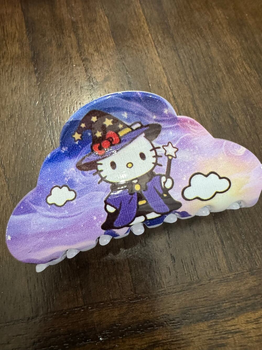 Hello Kitty purple and white cloud-shaped hair clip in a witch costume
